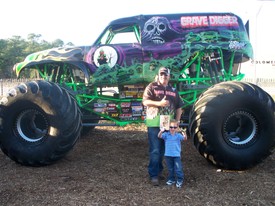 Fri 27 Feb 2009 06:31:27 PM

Grave Digger is Andrew's favorite monster truck.  This is Andrew and Dennis, one of Grave Digger's drivers.  Andrew got an autographed picture, also, which he is holding, along with his Grave Digger toy, in this photo.