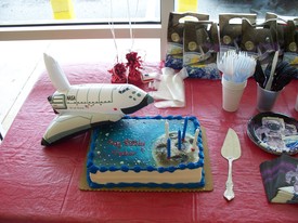 Sat 24 Apr 2010 12:02:21 PM

Andrew's party was space themed with an inflatable space shuttle and the candles stuck in the moon on the cake.